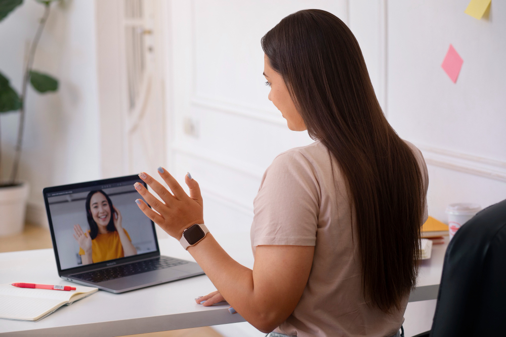 online therapy session with therapist waving