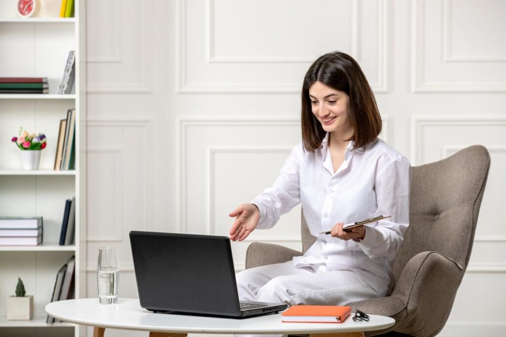 woman in white shirt having a virtual meeting