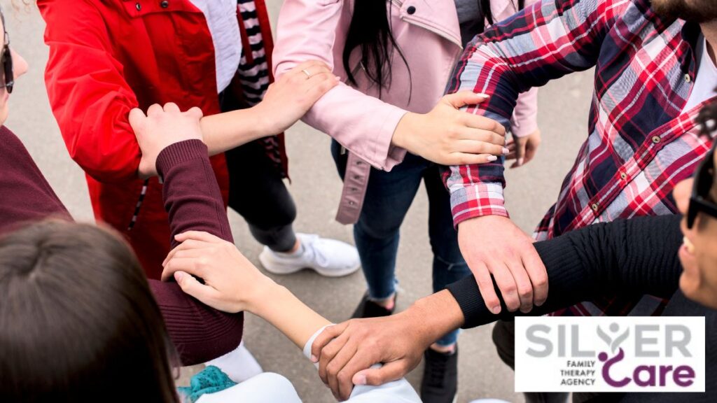 A group of teenagers interlocking their arms in solidarity, advocating for a cause and boosting self-esteem.